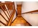 Wooden staircase with wooden banister, leading downwards to a lower level at 6980 Lamplighter Ln, Winston, GA 30187
