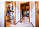 View of a walk-in closet and the main bedroom with wooden accents and a well-lit workspace beyond at 6980 Lamplighter Ln, Winston, GA 30187
