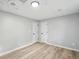 Finished basement area with neutral paint, wood-look floors, and two closet doors at 193 Cedar Creek Dr, Dallas, GA 30157