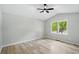 Vaulted bedroom has a window, and light, airy feel with neutral walls and wood-look flooring at 193 Cedar Creek Dr, Dallas, GA 30157
