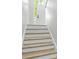 Inviting entryway featuring a bright front door with sidelight and stylish wood-look stairs at 193 Cedar Creek Dr, Dallas, GA 30157