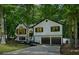 Traditional home with black window trim, a two-car garage, and lush green trees at 193 Cedar Creek Dr, Dallas, GA 30157