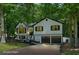 Traditional home with black window trim, a two-car garage, and lush green trees at 193 Cedar Creek Dr, Dallas, GA 30157