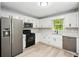 Well-lit kitchen with stainless steel appliances, sleek countertops and white cabinets at 193 Cedar Creek Dr, Dallas, GA 30157