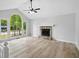 Spacious living room with vaulted ceiling, large windows, and stone fireplace, offering an airy and bright space at 193 Cedar Creek Dr, Dallas, GA 30157