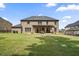 Expansive backyard with a well-maintained lawn, covered patio, and plenty of room for outdoor activities at 317 Basel Way, Hampton, GA 30228