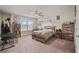 Bedroom with carpet floors, ceiling fan and natural light from the window at 317 Basel Way, Hampton, GA 30228