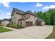 Brick two-story home with a spacious driveway and attached two-car garage at 317 Basel Way, Hampton, GA 30228