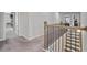Second-floor hallway featuring carpet floors and a dark wood railing at 317 Basel Way, Hampton, GA 30228