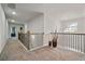 Open hallway featuring dark metal railings, a chandelier, and gray walls at 317 Basel Way, Hampton, GA 30228