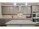 Stylish kitchen with modern appliances, granite countertops, a decorative backsplash and a large island at 317 Basel Way, Hampton, GA 30228
