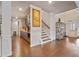Open-concept space with hardwood flooring and a staircase at 317 Basel Way, Hampton, GA 30228