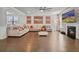 Inviting living room featuring a fireplace, hardwood floors, and a comfortable sectional sofa at 317 Basel Way, Hampton, GA 30228