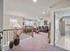 Spacious loft featuring carpet floors, a ceiling fan, recessed lights, and many windows at 317 Basel Way, Hampton, GA 30228