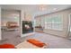 Sitting area in the main bedroom with a fireplace and window view at 317 Basel Way, Hampton, GA 30228