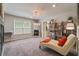 Sitting area in the main bedroom with a fireplace and a bookshelf at 317 Basel Way, Hampton, GA 30228