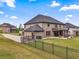 Spacious backyard with a well-maintained lawn, covered patio, and home exterior at 317 Basel Way, Hampton, GA 30228