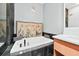 Bright bathroom features a soaking tub with elegant fixtures and a decorative screen backdrop at 3820 Roswell Ne Rd # 705, Atlanta, GA 30342