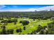 Expansive golf course community with lush greenery, a serene pond, and a stunning city skyline view at 3820 Roswell Ne Rd # 705, Atlanta, GA 30342