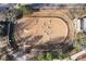 Aerial view of a well-maintained horse arena with sand and various obstacles at 3820 Roswell Ne Rd # 705, Atlanta, GA 30342