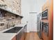 Modern kitchen with stainless steel appliances and hardwood floors at 3820 Roswell Ne Rd # 705, Atlanta, GA 30342
