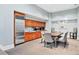 Open kitchenette with stainless steel refrigerator, wooden cabinetry, and dining area with seating at 3820 Roswell Ne Rd # 705, Atlanta, GA 30342