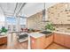 Open-concept living space featuring exposed brick and large windows at 3820 Roswell Ne Rd # 705, Atlanta, GA 30342