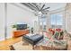 Bright living room with exposed brick wall, modern furniture, and views of the city at 3820 Roswell Ne Rd # 705, Atlanta, GA 30342