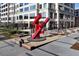 Artistic outdoor area with red sculpture, modern seating, and landscaping at Buckhead Village District, Atlanta at 3820 Roswell Ne Rd # 705, Atlanta, GA 30342