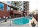 Beautiful pool area with lounge chairs, brick walls, and an outdoor patio at 3820 Roswell Ne Rd # 705, Atlanta, GA 30342
