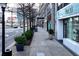 Street view with retail spaces, sidewalk, trees, streetlights, and passing cars, showing the lively commercial area at 3820 Roswell Ne Rd # 705, Atlanta, GA 30342