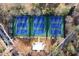 Aerial view of six beautifully maintained blue and green tennis courts surrounded by mature trees at 3820 Roswell Ne Rd # 705, Atlanta, GA 30342