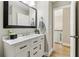 Bathroom showing white vanity with modern sink and a black framed mirror at 7160 Royston Way, Cumming, GA 30028