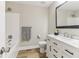 This bathroom features a tub, toilet, vanity with black hardware, and a large mirror at 7160 Royston Way, Cumming, GA 30028