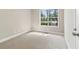Empty bedroom with neutral walls, carpet flooring, and large window at 7160 Royston Way, Cumming, GA 30028