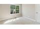 Bright empty bedroom with large window and neutral carpeting at 7160 Royston Way, Cumming, GA 30028
