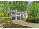 Exterior shot of two-story house with gray roof, bay window, covered entrance, and an attached garage at 7160 Royston Way, Cumming, GA 30028