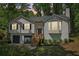 Two-story house with gray siding, bay window, covered entrance, and an attached garage at 7160 Royston Way, Cumming, GA 30028