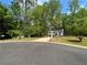 Beautiful 2-story house features a well-manicured lawn, driveway and is surrounded by mature trees at 7160 Royston Way, Cumming, GA 30028