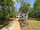 Charming two-story home featuring a well-manicured lawn, flower bed, and a double-car garage at 7160 Royston Way, Cumming, GA 30028
