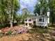 Charming two-story home with a bay window, flower beds, and a double-car garage at 7160 Royston Way, Cumming, GA 30028