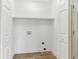 All-white laundry closet with upper shelf and hookups at 7160 Royston Way, Cumming, GA 30028