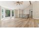 Spacious living area with high ceilings, wood floors, and large windows creating a bright atmosphere at 7160 Royston Way, Cumming, GA 30028