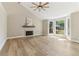 Bright living room with fireplace, vaulted ceilings, and large windows at 7160 Royston Way, Cumming, GA 30028