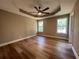 Calm main bedroom featuring trey ceilings, neutral walls, and gleaming hardwood floors at 7160 Royston Way, Cumming, GA 30028