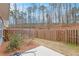 Backyard view features a fenced yard and mature trees and plantings at 305 Duval Dr, Alpharetta, GA 30009