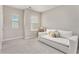 Cozy bedroom with natural light, plush carpeting, and a comfortable daybed for relaxing at 305 Duval Dr, Alpharetta, GA 30009