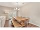 Bright dining room with a large wooden table, bench, and modern chandelier at 305 Duval Dr, Alpharetta, GA 30009