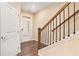 Welcoming entryway with hardwood floors and a staircase with wooden and wrought iron details at 305 Duval Dr, Alpharetta, GA 30009