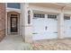 Close up of the main door and a 2-car garage of a nice townhouse at 305 Duval Dr, Alpharetta, GA 30009